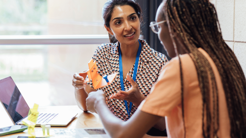 Two people undertaking training in a charity in an office.